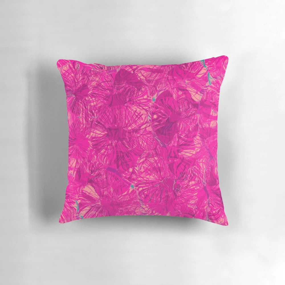 Closeup of a vibrant magenta and pink abstract pattern pillow with fluid, swirling shapes and circles.