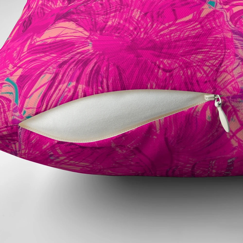 Closeup of a vibrant magenta and pink abstract pattern pillow with fluid, swirling shapes and circles.