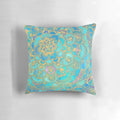 A decorative pillow with a mandala design in teal, turquoise, gold, and yellow hues, inspired by stained glass and bohemian styles.