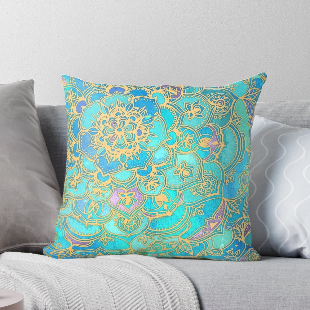 A decorative pillow with a mandala design in teal, turquoise, gold, and yellow hues, inspired by stained glass and bohemian styles.