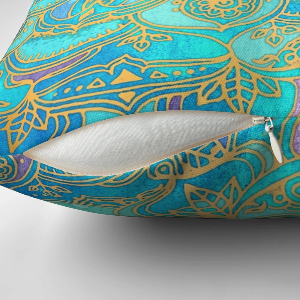A decorative pillow with a mandala design in teal, turquoise, gold, and yellow hues, inspired by stained glass and bohemian styles.