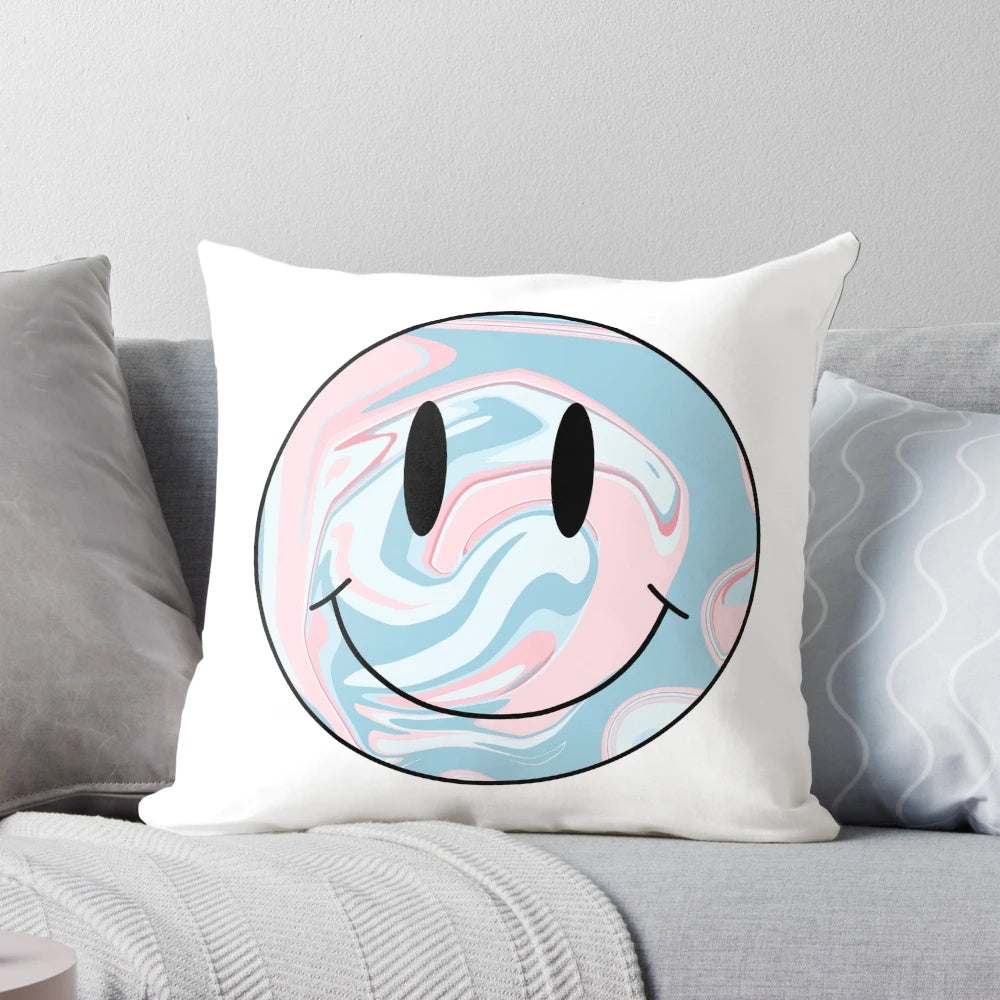 A colorful marble-patterned pillow with a happy smiley face design, perfect for adding a touch of whimsy to any space.