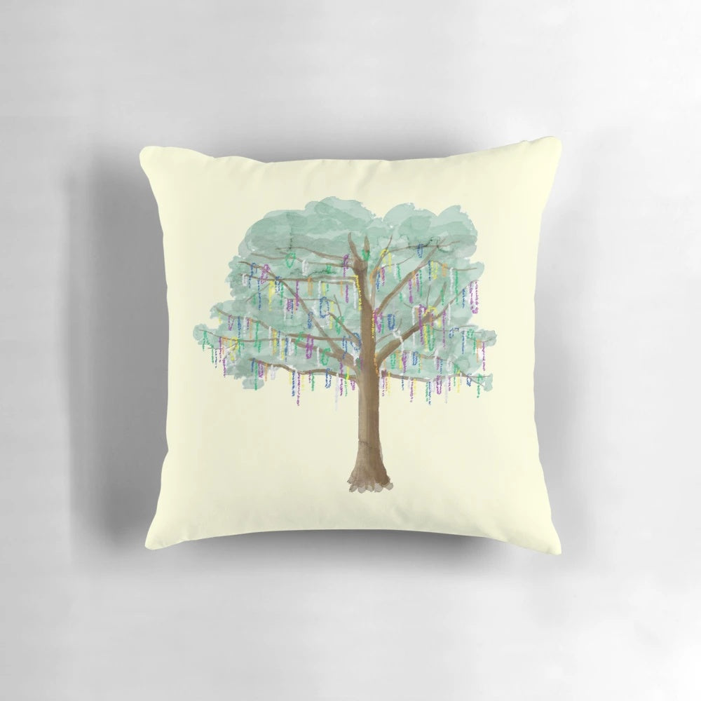 Watercolor painting of a colorful Mardi Gras tree with beads and foliage on a throw pillow