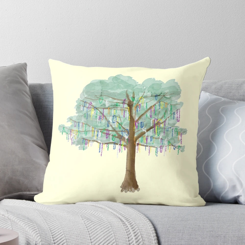 Watercolor painting of a colorful Mardi Gras tree with beads and foliage on a throw pillow