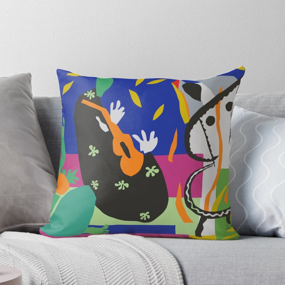 A vibrant, abstract decorative pillow featuring a Matisse-inspired cut out collage design with colorful triangular shapes.