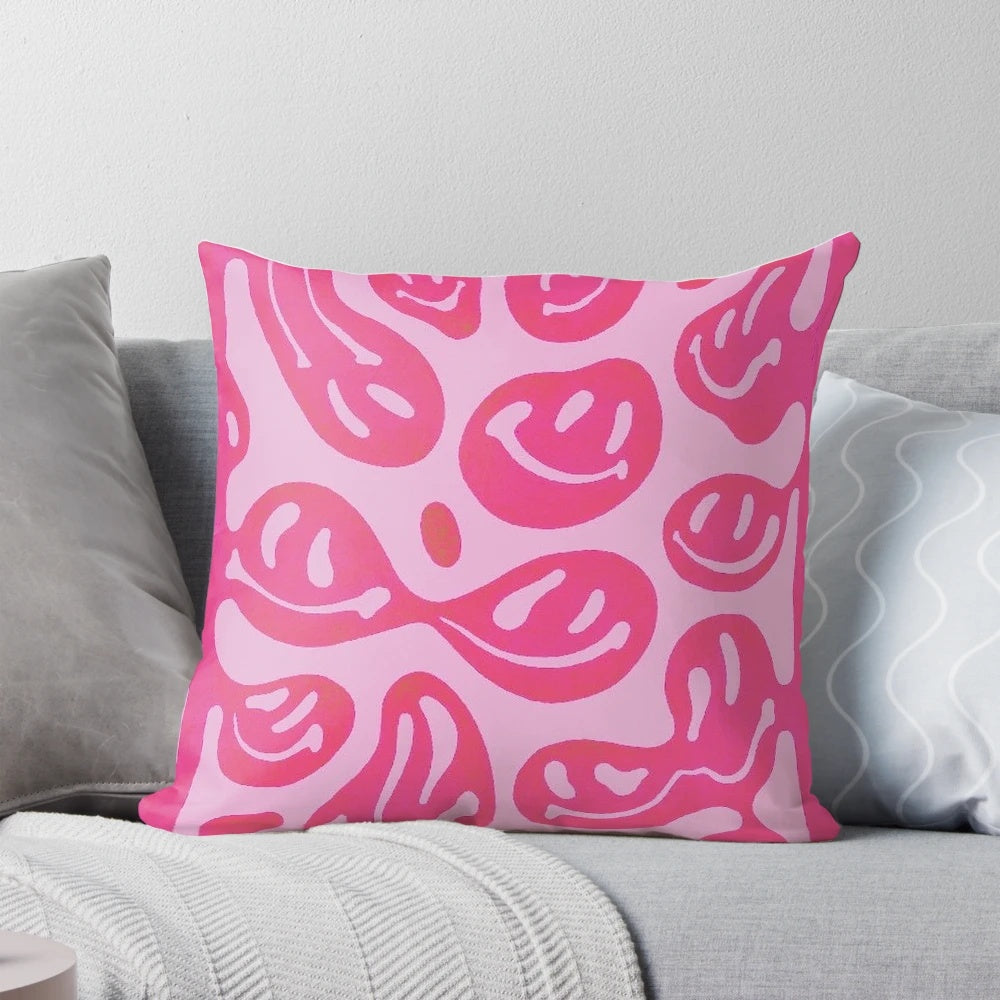 Colorful melted smiley face design on a pink pillow, with a psychedelic, vibrant pattern.