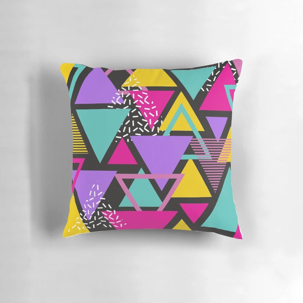 Colorful Memphis-inspired triangle pattern pillow with a vintage, geometric design.