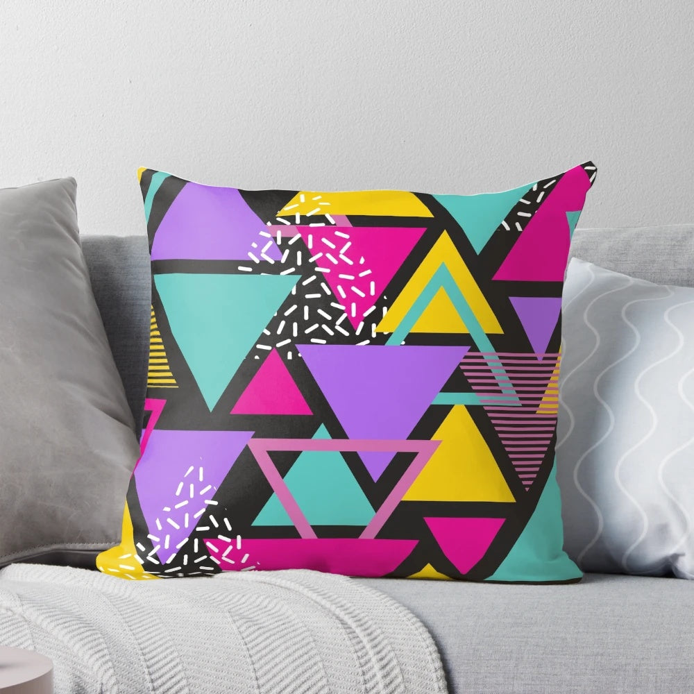 Colorful Memphis-inspired triangle pattern pillow with a vintage, geometric design.