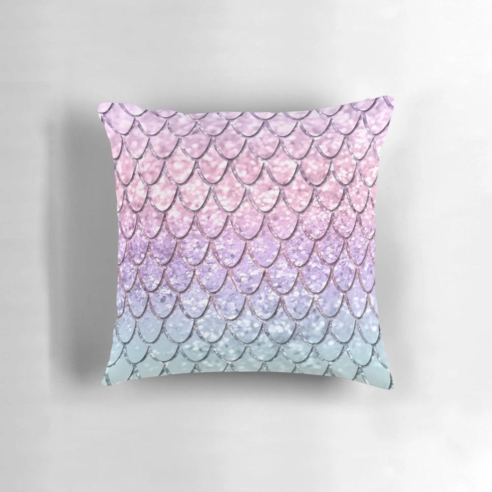 Colorful pillow with a digital collage design featuring mermaid scales and unicorn-inspired glitter patterns.