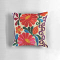 Closeup of a pillow featuring a colorful Mexican floral pattern