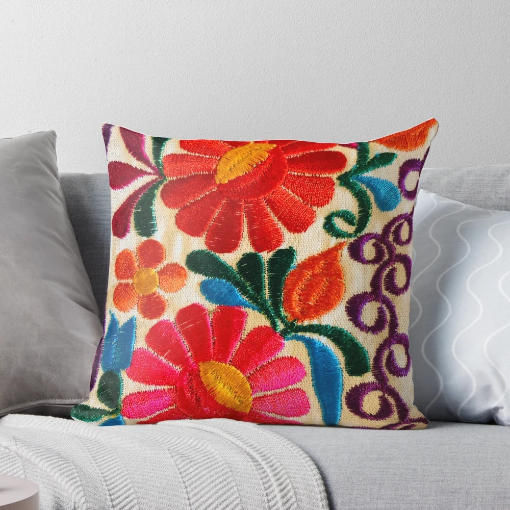 Closeup of a pillow featuring a colorful Mexican floral pattern