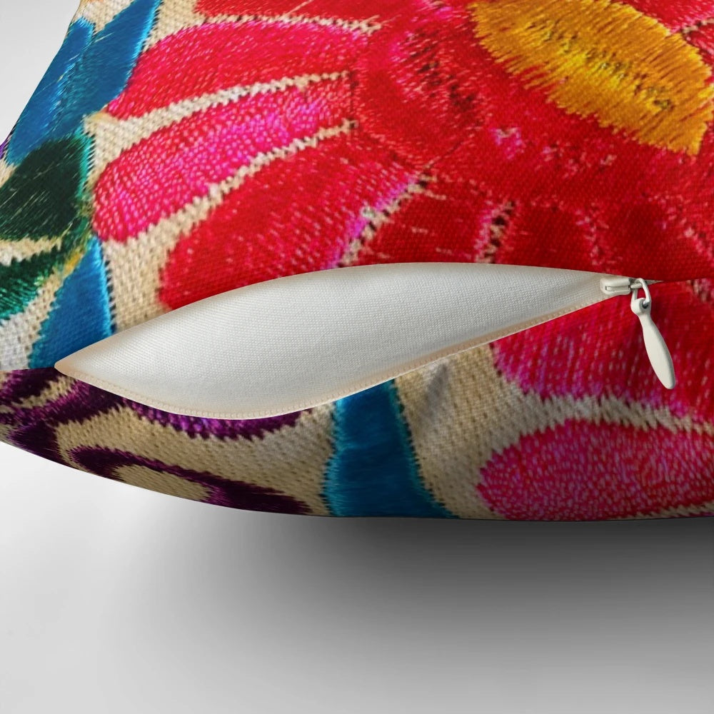 Closeup of a pillow featuring a colorful Mexican floral pattern