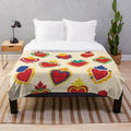 Beige plush blanket with colorful Mexican-inspired sacred hearts pattern