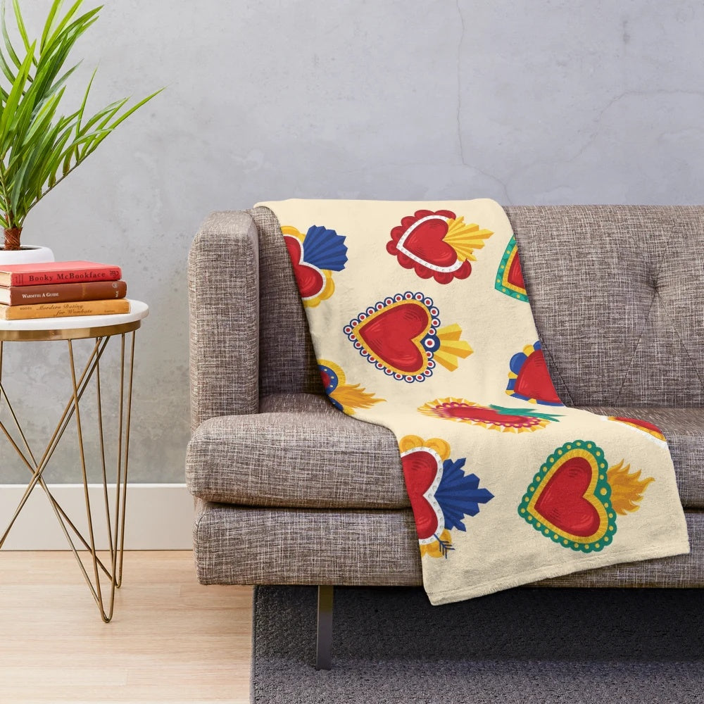 Beige plush blanket with colorful Mexican-inspired sacred hearts pattern