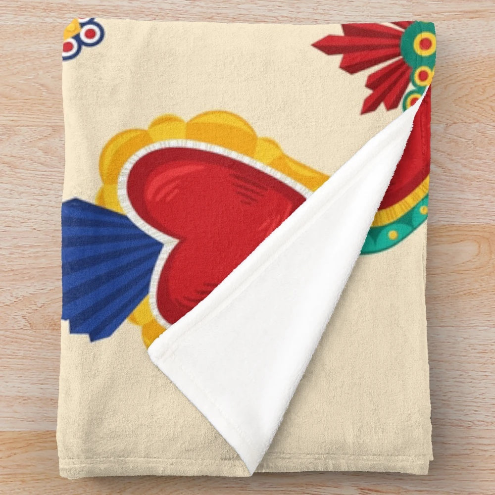 Beige plush blanket with colorful Mexican-inspired sacred hearts pattern