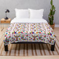 Colorful Mexican Otomi inspired plush blanket featuring vibrant patterns of birds, flowers, and animals