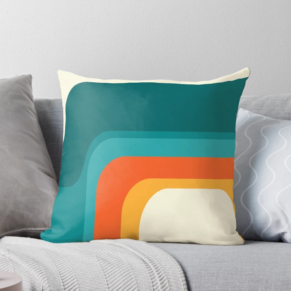 Colorful mid-century modern style rainbow throw pillow with teal, yellow, and orange hues