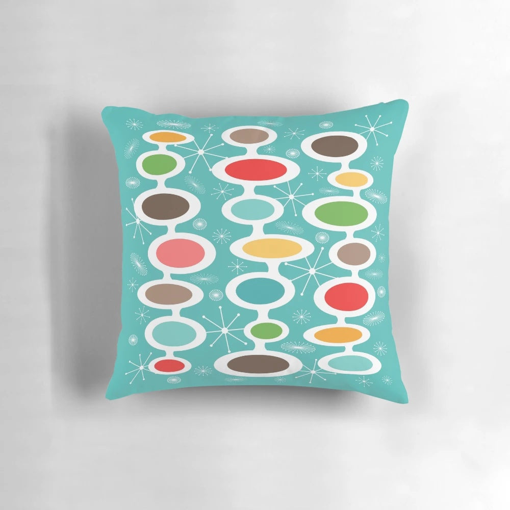 Colorful mid-century modern oval design throw pillow with abstract bubble pattern, inspired by atomic era art