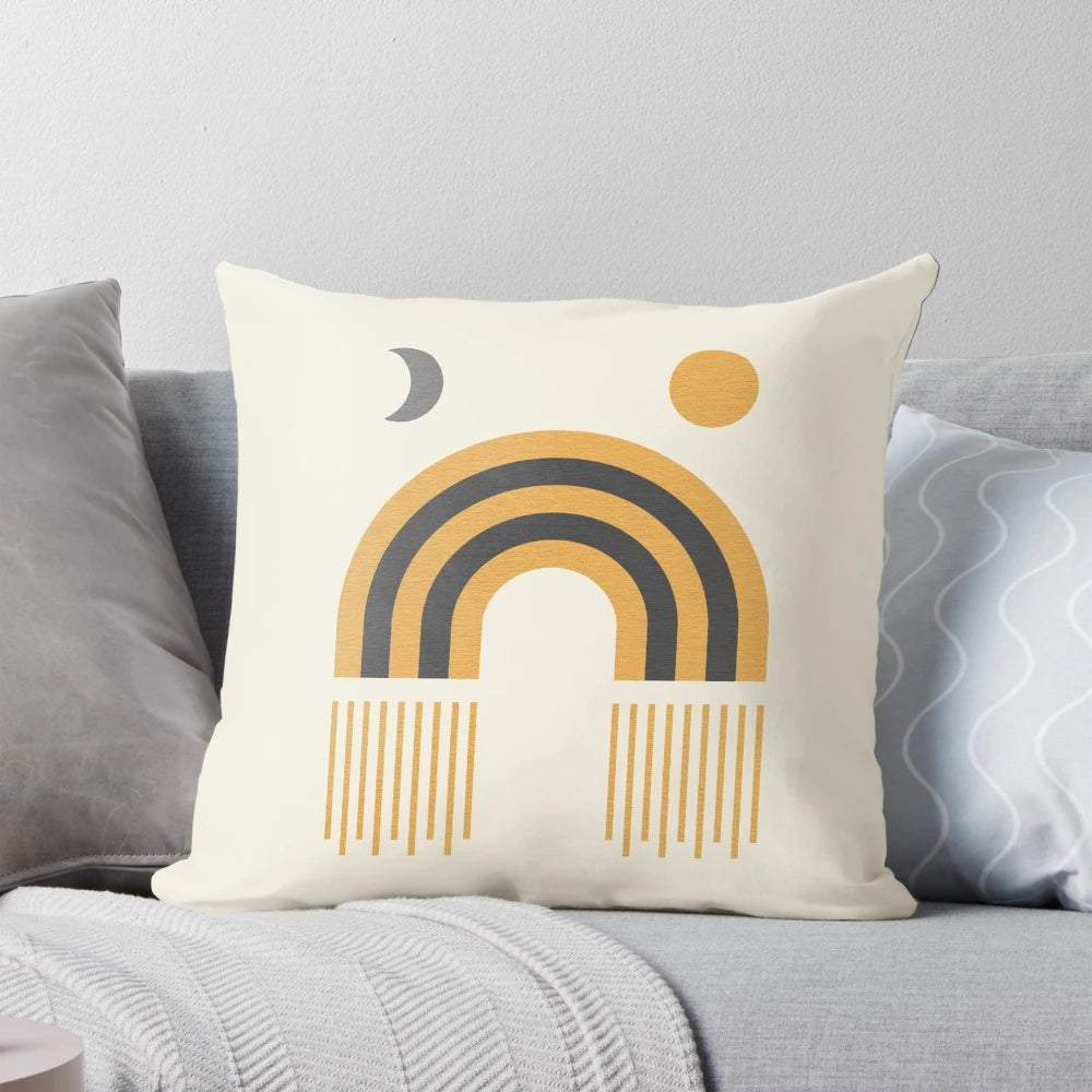 Mid-century modern pillow featuring a stylized sun and moon design in a geometric, abstract pattern.