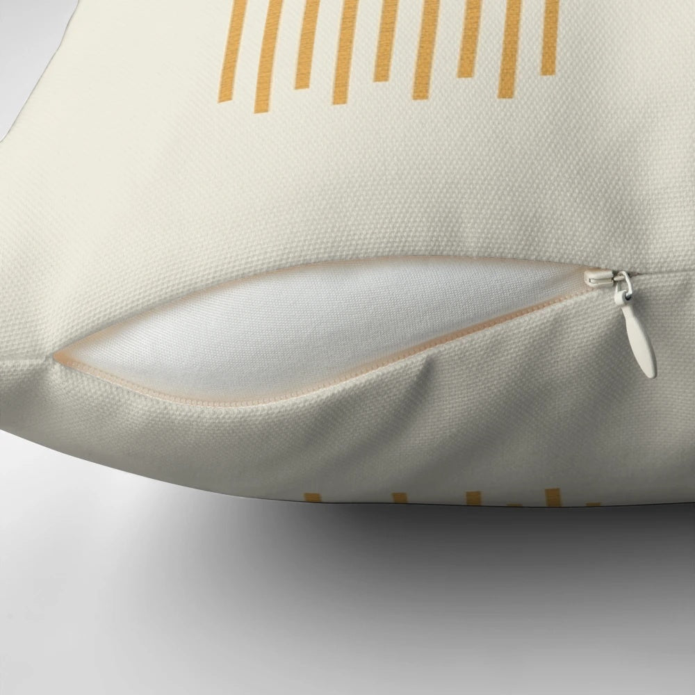 Mid-century modern pillow featuring a stylized sun and moon design in a geometric, abstract pattern.