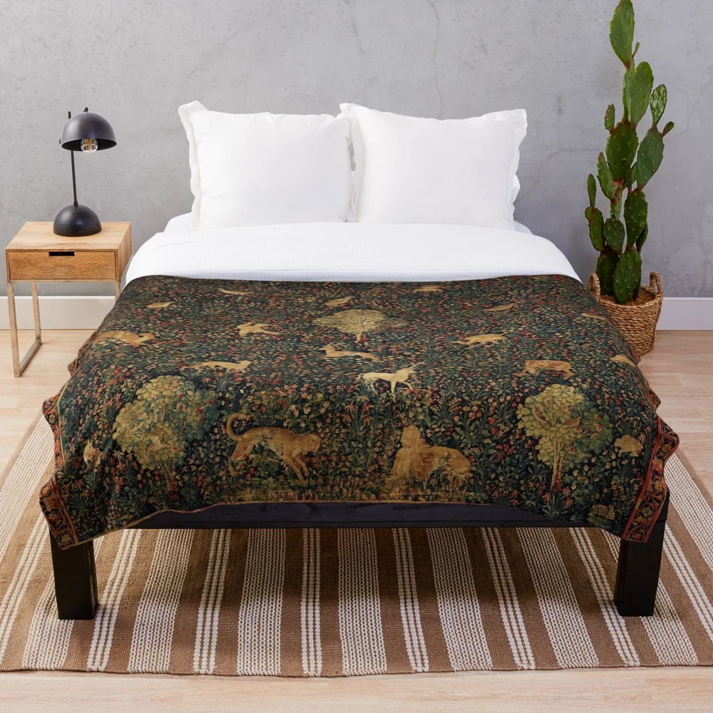 Millefleurs tapestry plush blanket featuring a fantasy medieval scene with a unicorn, deer, and other mythical creatures