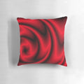 A decorative red, black, and white abstract swirl pattern throw pillow.