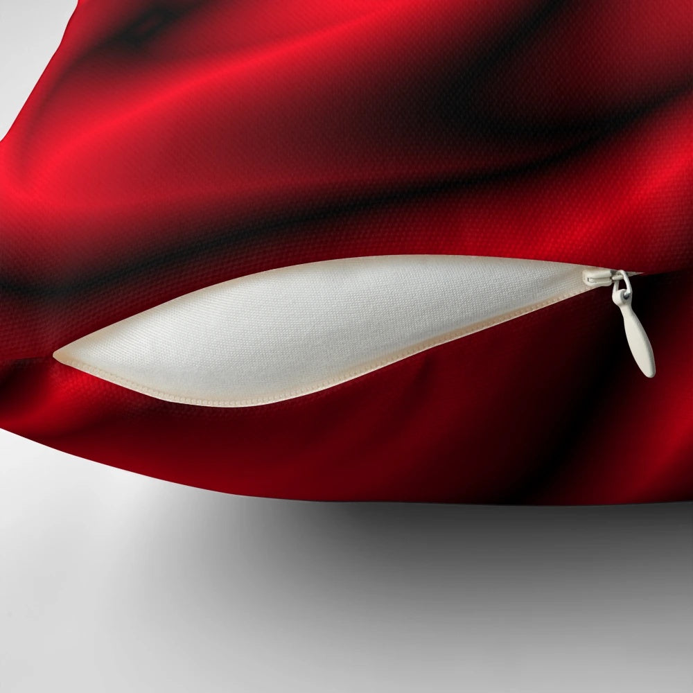A decorative red, black, and white abstract swirl pattern throw pillow.