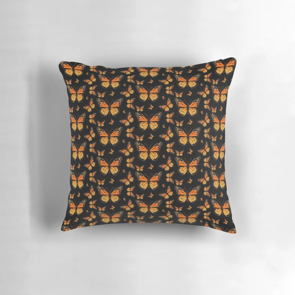 Monarch butterfly printed on a plush, decorative pillow with a vibrant, nature-inspired pattern.