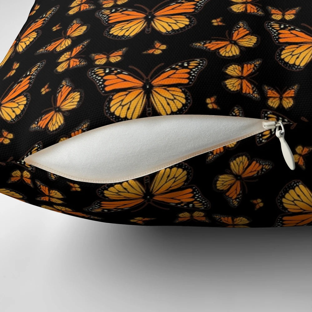 Monarch butterfly printed on a plush, decorative pillow with a vibrant, nature-inspired pattern.