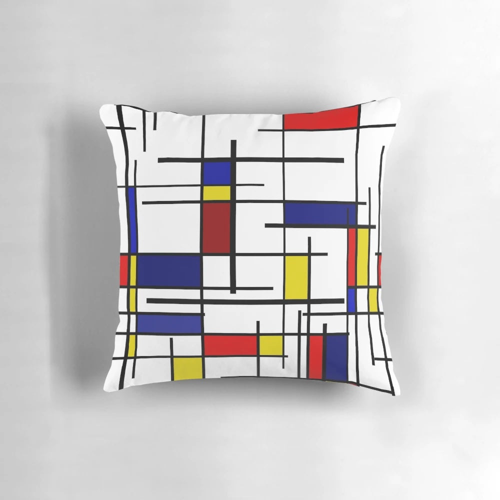 Colorful pillow with Mondrian-style geometric patterns in primary colors