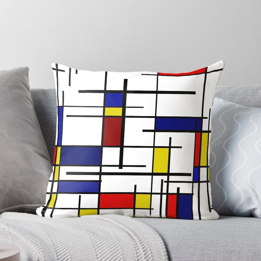 Colorful pillow with Mondrian-style geometric patterns in primary colors