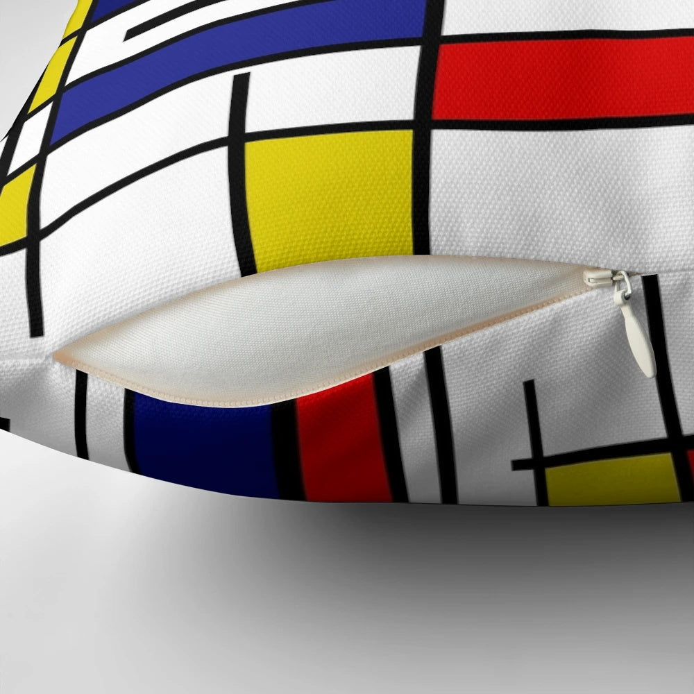 Colorful pillow with Mondrian-style geometric patterns in primary colors