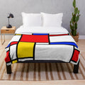 Mondrian-inspired plush blanket with bold primary colors and geometric patterns