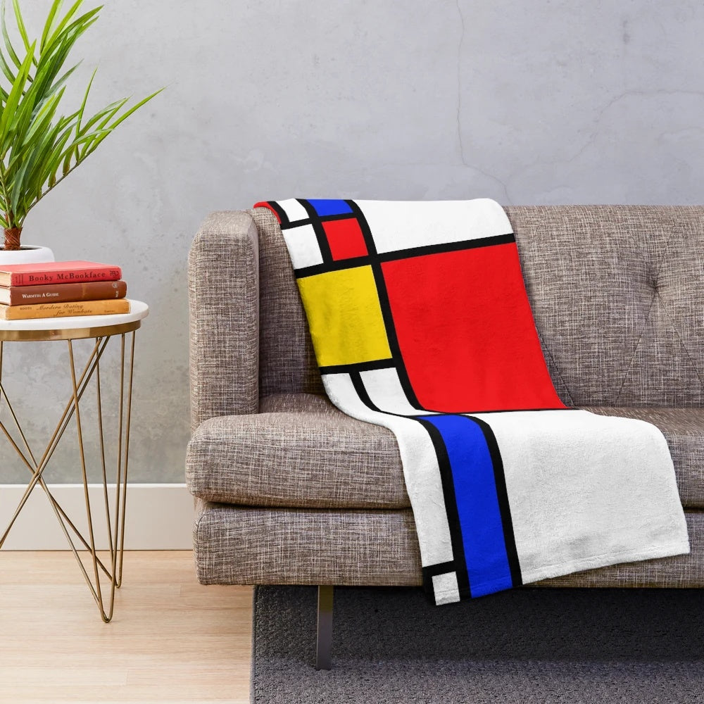 Mondrian-inspired plush blanket with bold primary colors and geometric patterns