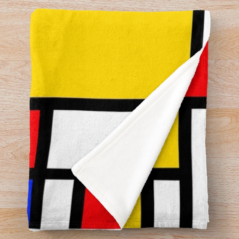 Mondrian-inspired plush blanket with bold primary colors and geometric patterns