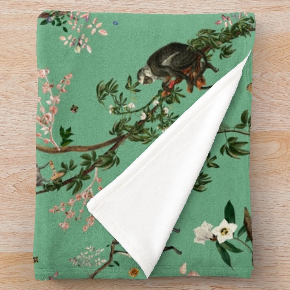 Monkey World Green Plush Blanket featuring a lush floral and botanical design