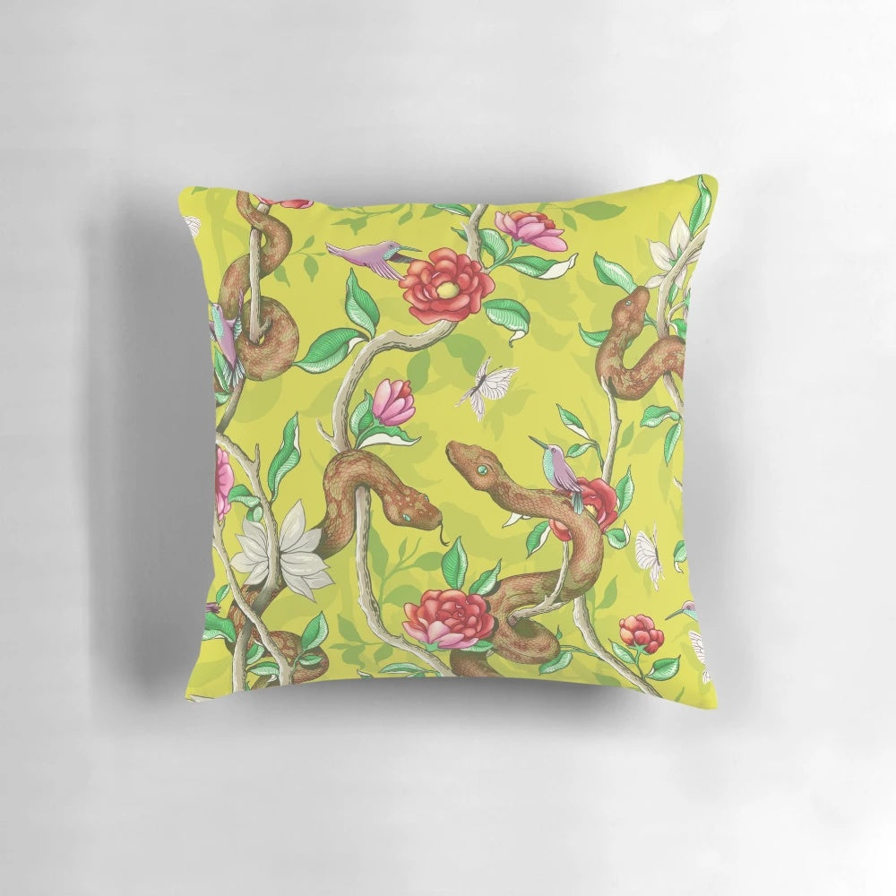 Colorful mustard-colored pillow with a vibrant floral and snake pattern, perfect for adding a touch of nature to your home.
