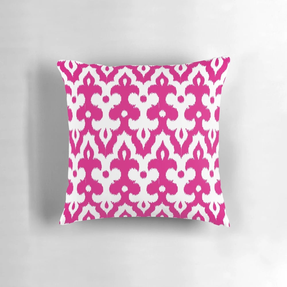 Fuchsia pink and white damask-patterned throw pillow with Moroccan, ikat, and arabesque design elements.