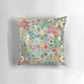 Colorful Moroccan-style mosaic pattern pillow in various shades of blue, pink, orange, and gold.