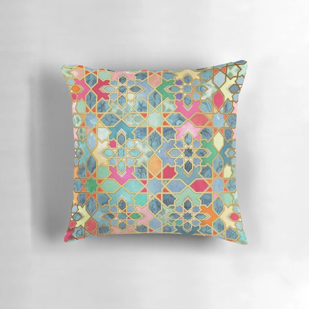 Colorful Moroccan-style mosaic pattern pillow in various shades of blue, pink, orange, and gold.