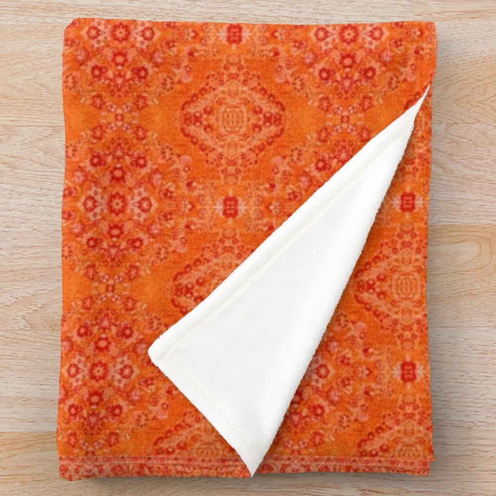 Cozy orange plush blanket with Moroccan-inspired design
