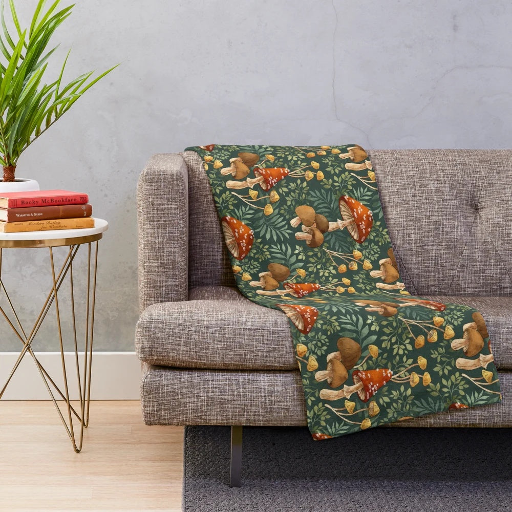 Whimsical plush blanket featuring a repeating pattern of colorful digital mushroom illustrations