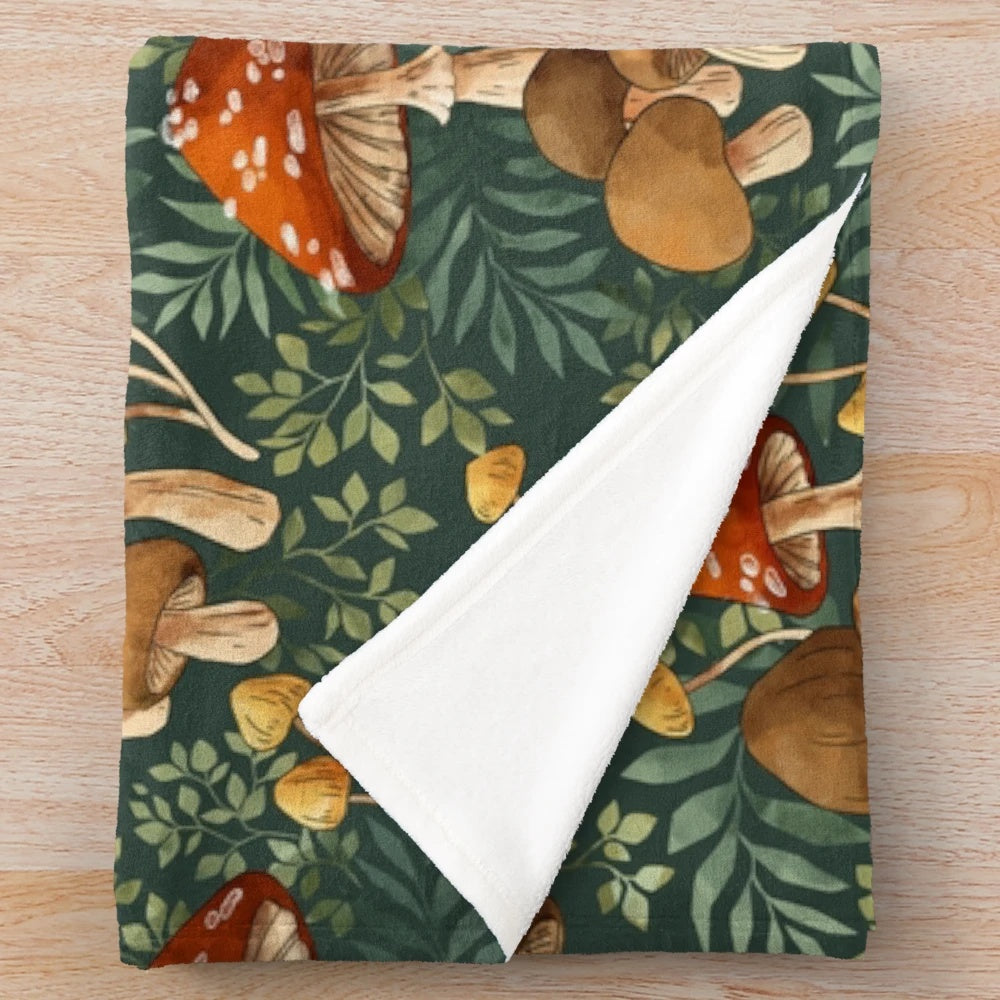 Whimsical plush blanket featuring a repeating pattern of colorful digital mushroom illustrations