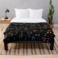 Colorful plush musical blanket with watercolor-style music notes