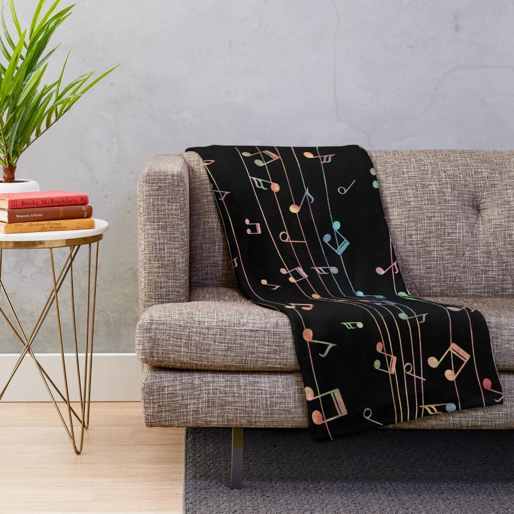 Colorful plush musical blanket with watercolor-style music notes