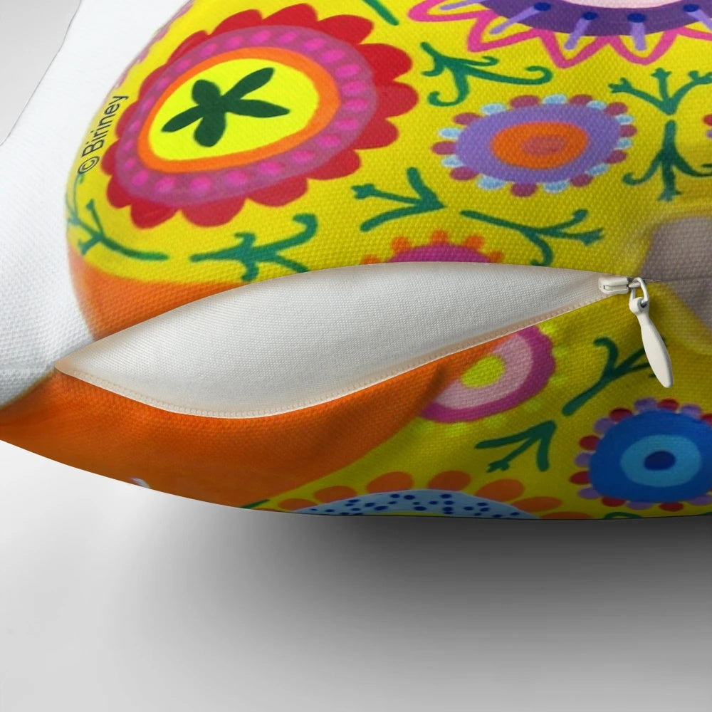 Vibrant orange pillow featuring a Nana-style design, a tribute to the iconic sculptures of Niki de Saint Phalle