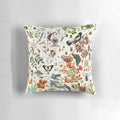 Closeup of a vibrant nature-inspired throw pillow featuring detailed illustrations of butterflies, birds, and flowers.