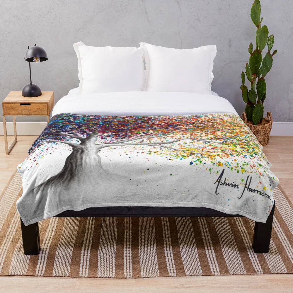 Colorful and whimsical plush blanket featuring an expressionist nature-inspired design