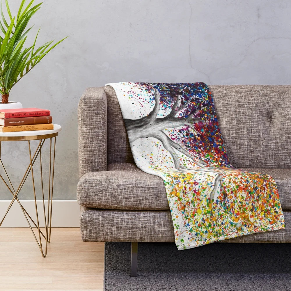 Colorful and whimsical plush blanket featuring an expressionist nature-inspired design