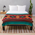 Navajo-inspired plush blanket with vibrant geometric patterns and teal border